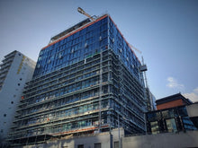 Load image into Gallery viewer, The International Apartments under construction. Scaffolding being removed using Advance Guardrail &amp; Geda 200 Material Hoist
